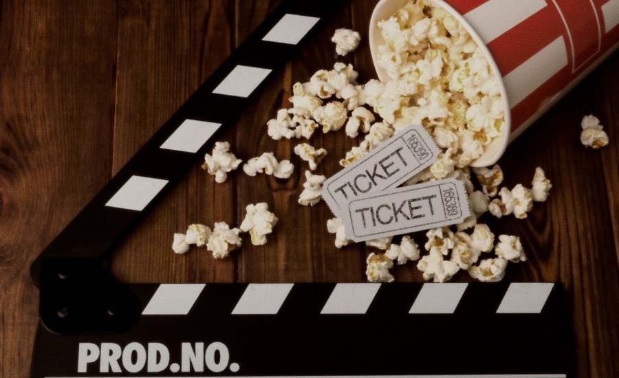 a photo of popcorn and movie tickets