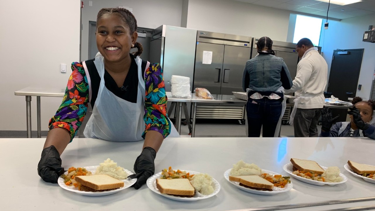 Khloe Thompson of Khloe Kares handing out food