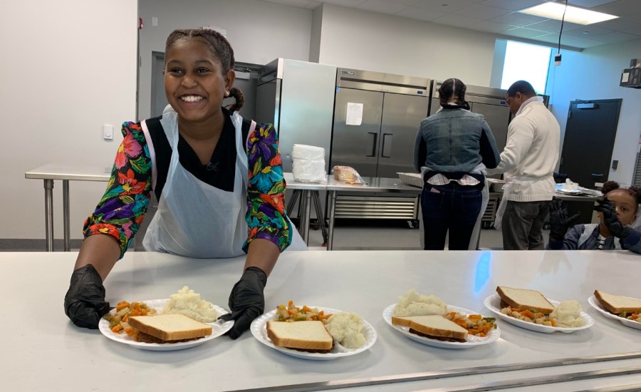 Khloe Thompson of Khloe Kares handing out food