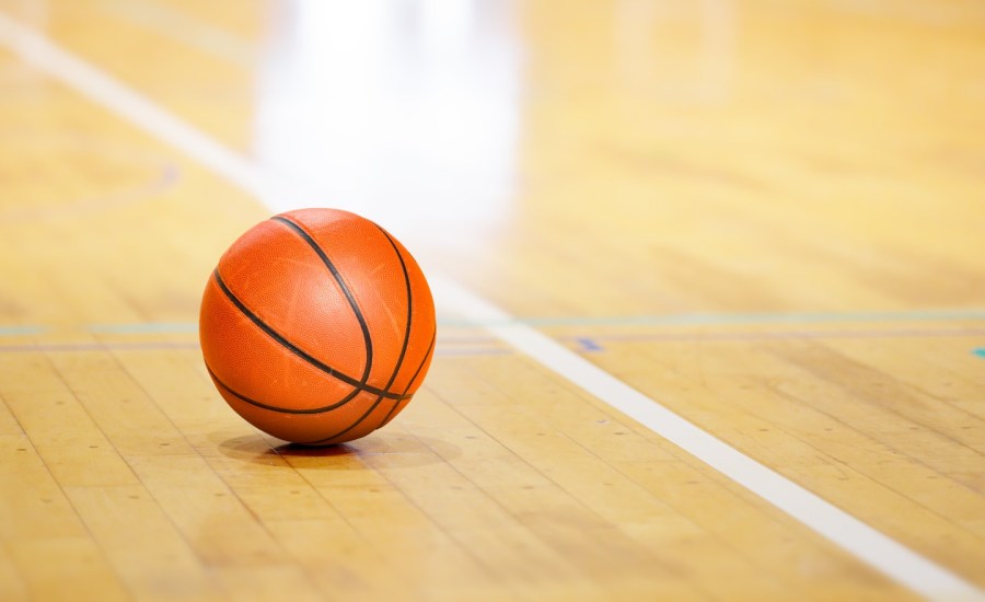 a basketball next to the sideline on a basketball court