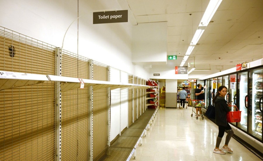 empty shelves in the toilet paper section of a grocery store