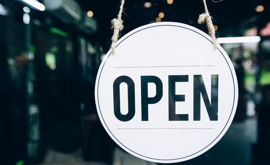 an open sign in front of a cafe