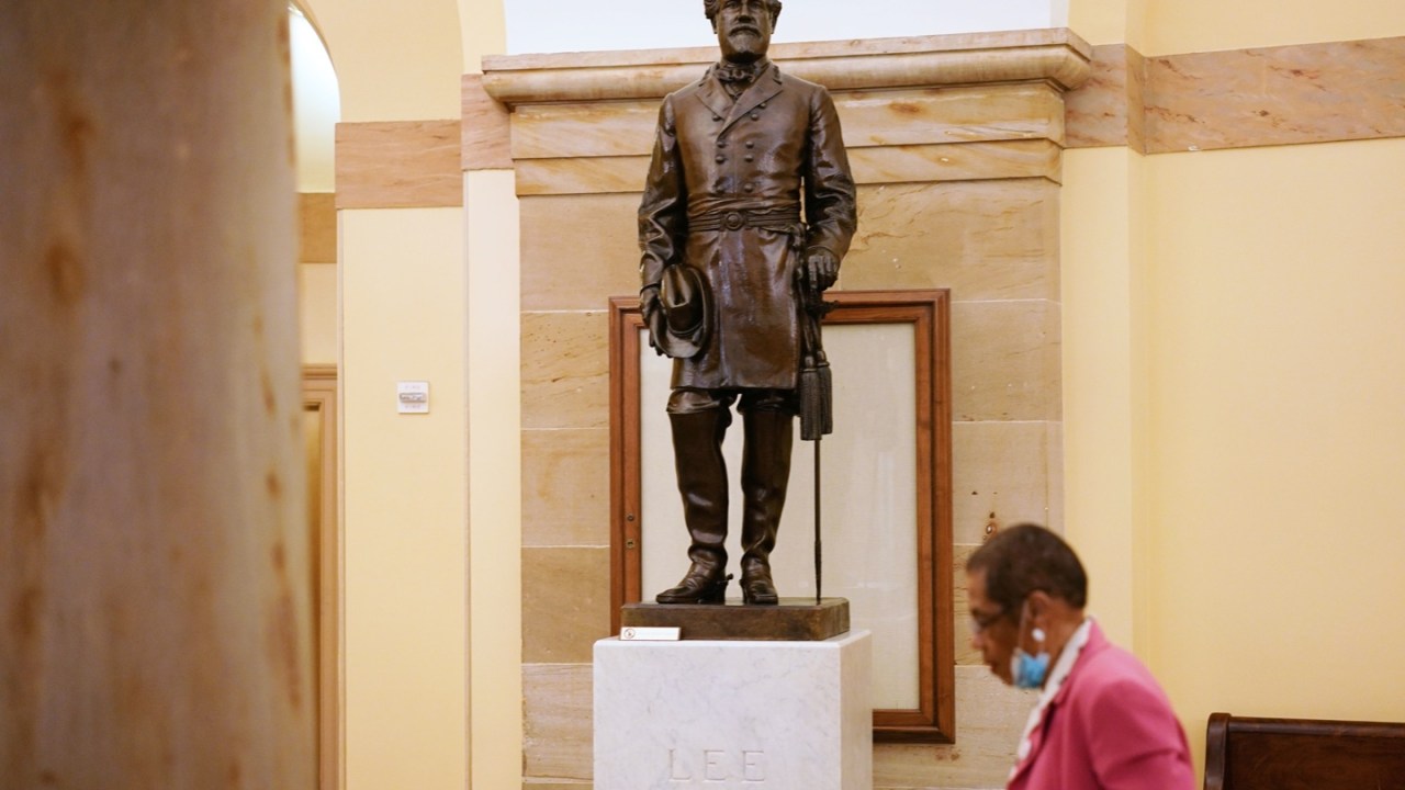 District of Columbia delegate to the House of Representatives, Eleanor Holmes Norton, walks past a statue of Robert E. Lee, commander of the Confederate States Army, in the Crypt of the US Capitol