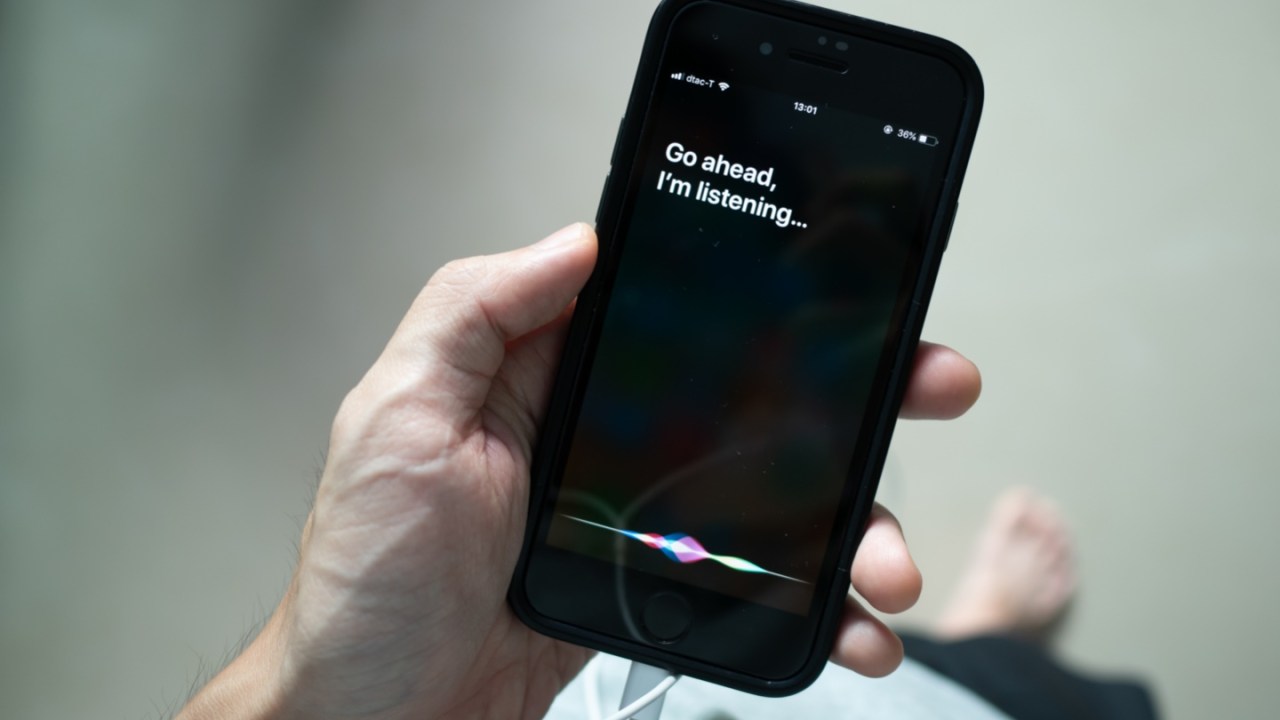 Siri, Apple's voice-activated digital assistant, tells iPhone user to ask her by showing the text "Go ahead, I'm listening" on the display
