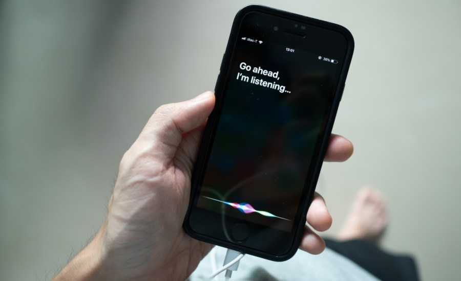 Siri, Apple's voice-activated digital assistant, tells iPhone user to ask her by showing the text "Go ahead, I'm listening" on the display