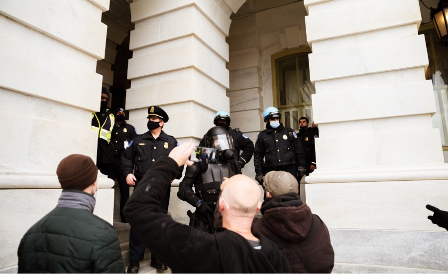 A group of pro-Trump protesters argue with Capitol Police after storming the grounds of the Capitol Building on January 6, 2021 in Washington, DC.