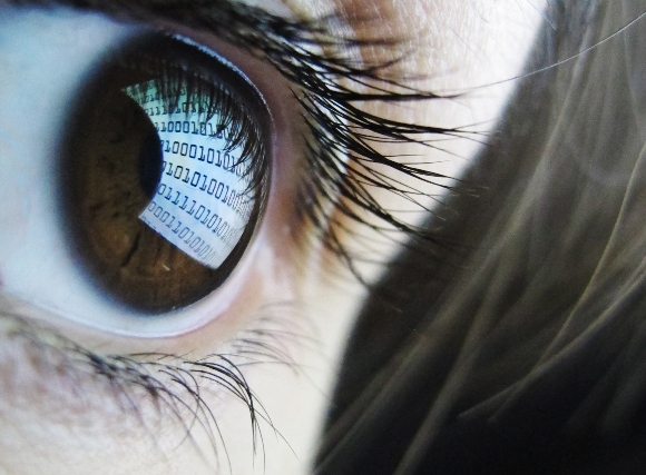 Computer code is reflected in a user's eye