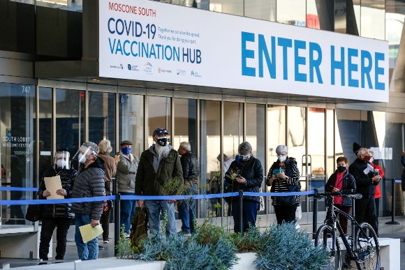 People wait in line for coronavirus vaccine