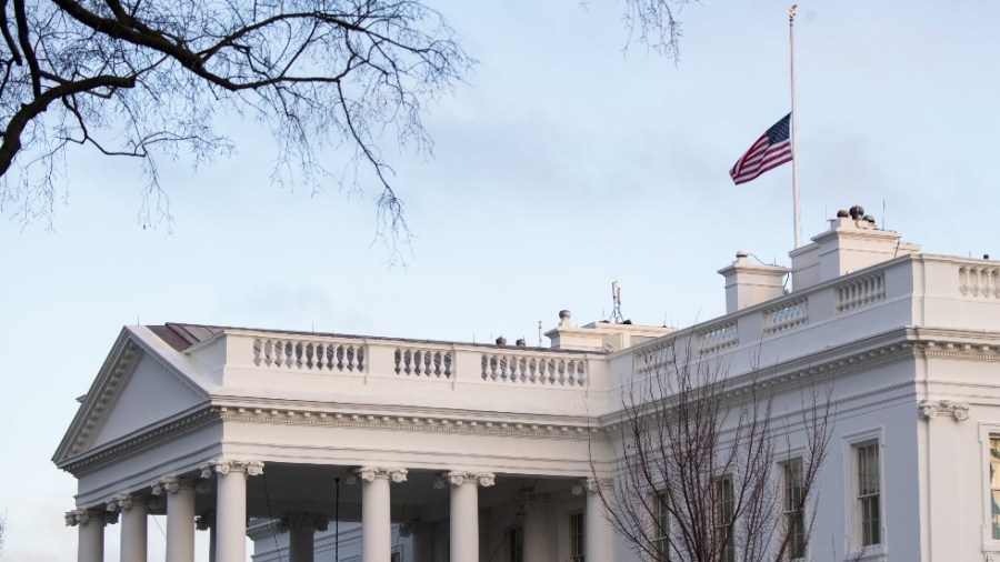 The U.S. flag over the White House flies at half-staff in honor of the 500,000 Americans killed by COVID-19