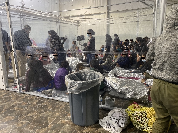 Migrants crowd a Border Patrol facility