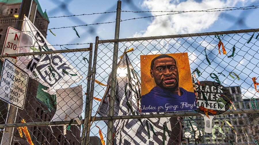 A poster of George Floyd sits on a security fence as trial of Derek Chauvin goes on