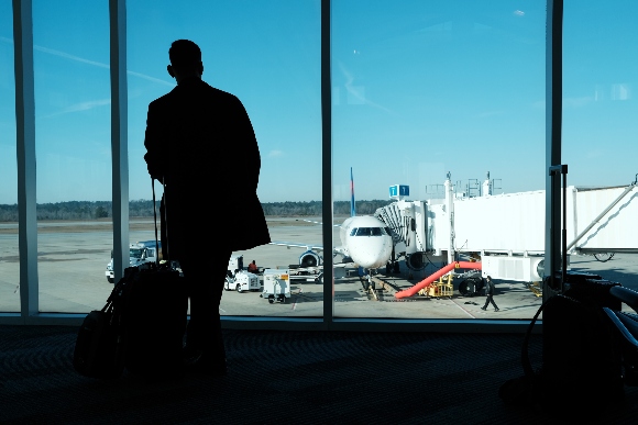 An airline traveler at an airport window