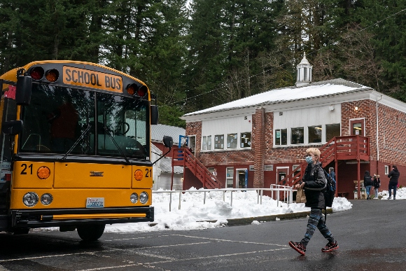 A child walks to a school bus