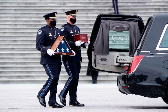 The remains of Capitol Police Officer Brian Sicknick are carried down the East Front steps