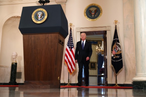 President Biden walks to a podium