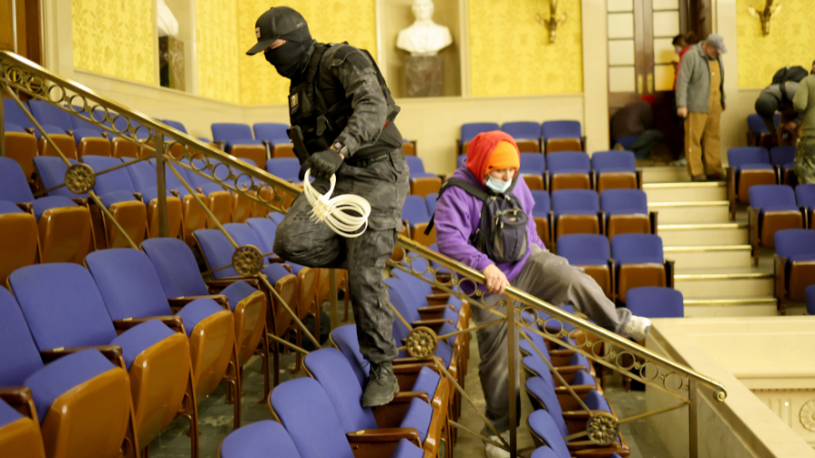 Pro-Trump rioters scale the Senate chambers on Jan. 6, 2021