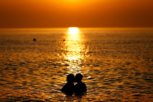 Couple kissing in the ocean