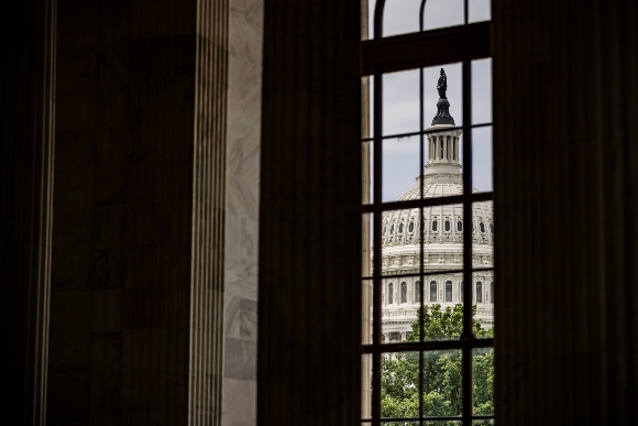 The U.S. Capitol Dome is seen through a window in the in the Rotunda of the Russell Senate Office Building