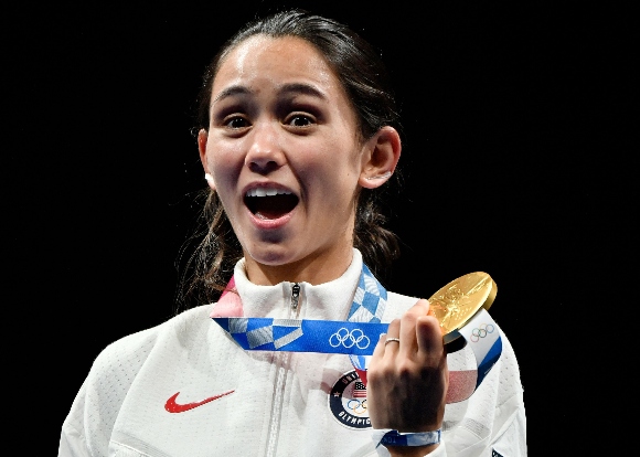 Gold medallist USA's Lee Kiefer celebrate on podium during the medal ceremony for the women's foil individual