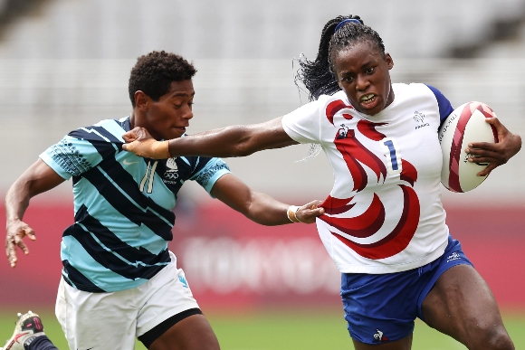 Seraphine Okemba of Team France attempts to evade the tackle of Maria Naimasi Ana of Team Fiji in the Women’s pool B match