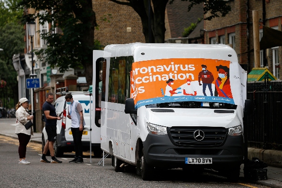 A Coronavirus vaccination bus operates outside Park Walk Primary School on July 4, 2021 in London