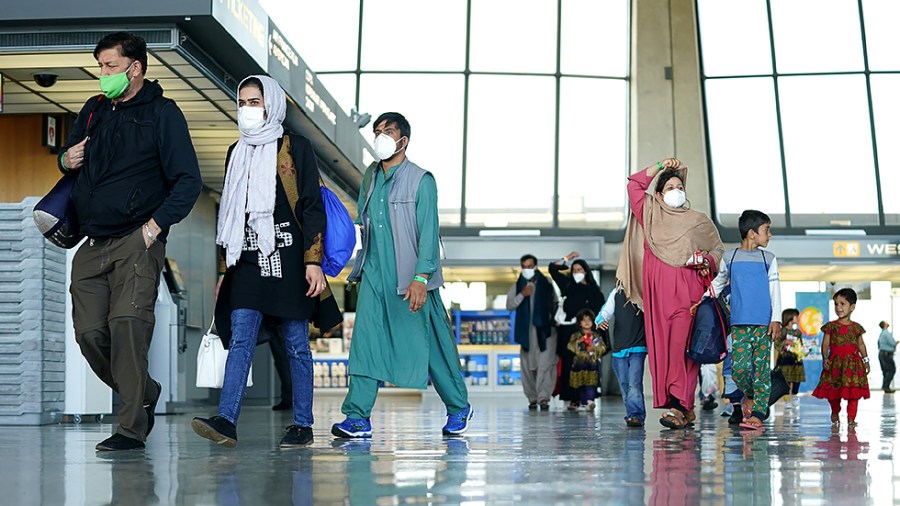 Afghan refugees displaced from their homes due to the Taliban takeover arrive at Washington Dulles International Airport in Chantilly, Va., on Monday, August 30, 2021.