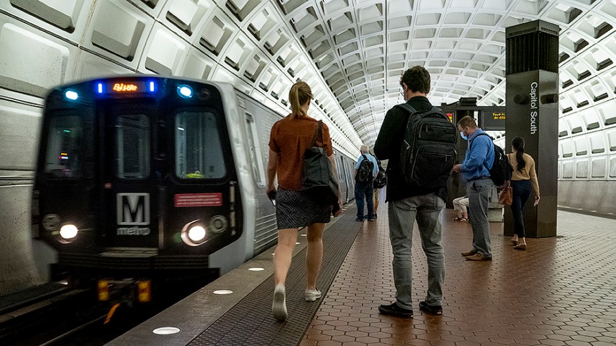 Metro riders are seen at the Capitol South Metro Station in Washington, D.C., Wednesday, August 4, 2021.