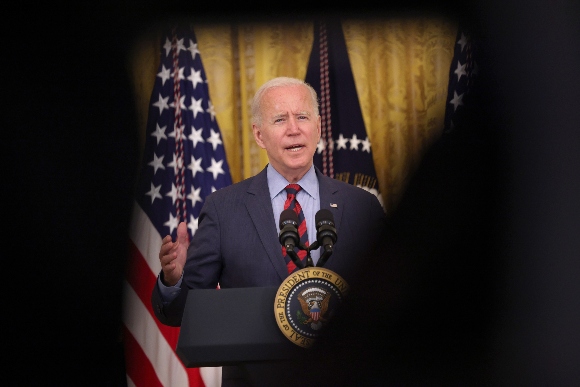 President Joe Biden speaks during an event in the East Room of the White House