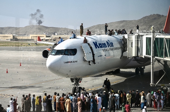 Crowds swarm a jet at the Kabul airport