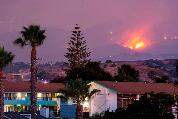 The Cave fire burns a hillside above houses in Santa Barbara, California