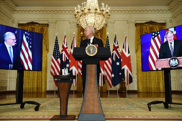 US President Joe Biden participates is a virtual press conference on national security with British Prime Minister Boris Johnson (R) and Australian Prime Minister Scott Morrison