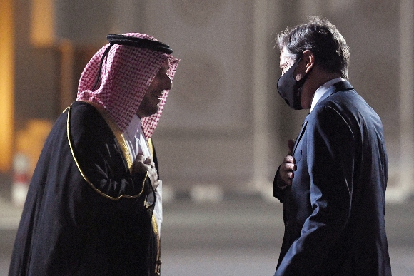 US Secretary of State Antony Blinken (R) is welcomed upon his arrival by MFA Director of Protocol Ambassador Ibrahim Fakhro (L) at Old Doha Airport in Qatar's capital