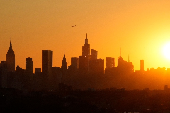 The New York skyline is seen as the sun sets