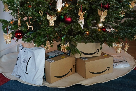 Packages from Amazon sent by relatives pile up under the photographer's Christmas tree