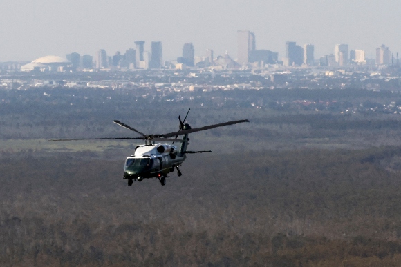 The skyline of New Orleans is seen in the background as US President Joe Biden onboard Marine One inspects the damage from Hurricane Ida