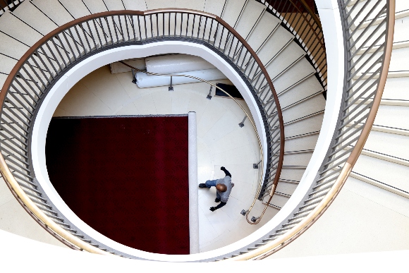 A staffer rolls up a carpet in a stairwell in the Capitol Visitor Center