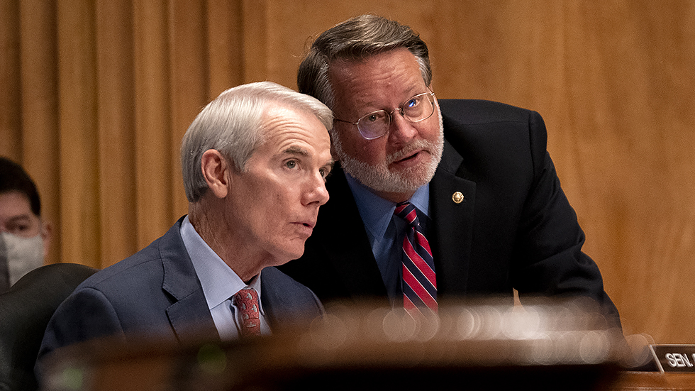 Sen. Rob Portman (R-Ohio) speaks to Sen. Gary Peters (D-Mich.) during a Senate Homeland Security & Governmental Affairs Committee hearing to discuss security threats 20 years after the 9/11 terrorist attacks on Tuesday, September 21, 2021.