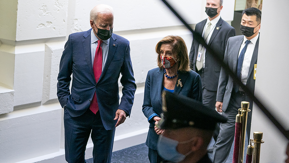 President Biden listens to Speaker Nancy Pelosi (D-Calif.) after a Democratic Caucus meeting at the Capitol to discuss the bipartisan infrastructure plan on Friday, October 1, 2021.