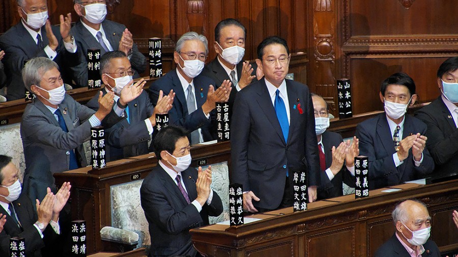 Newly-elected Japan's Prime Minister Fumio Kishida stands after the election for the new Prime Minister at Lower House's plenary session at the National Diet in Tokyo, Japan on Monday, October 4, 2021.