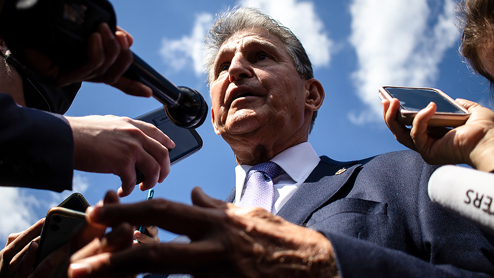 Sen. Joe Manchin (D-W.Va.) talks to reporters outside the Capitol on Thursday, September 30, 2021.