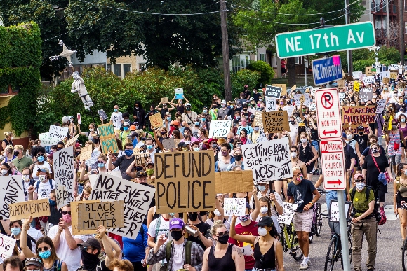 Demonstrators march against racism and police brutality and to defund the Minneapolis Police Department