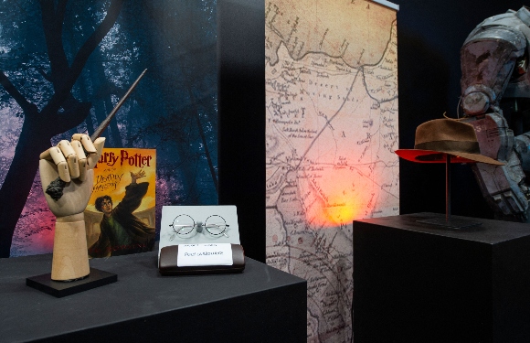 Harry Potter's wand and eyeglasses and a copy of "Harry Potter and the Deathly Hallows" are exhibited 