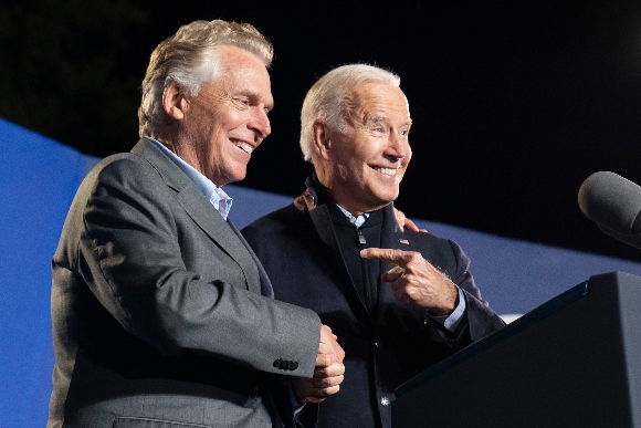 President Joe Biden, right, reacts after speaking at a rally for Democratic gubernatorial candidate, former Virginia Gov. Terry McAuliffe