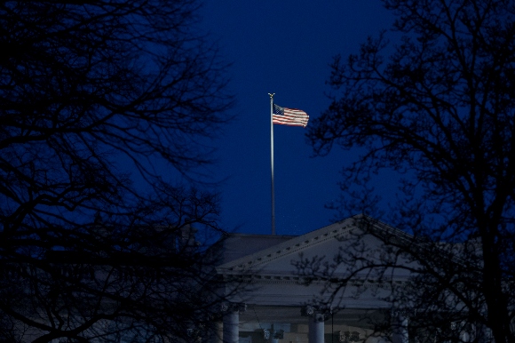 The US flag flying over the White House