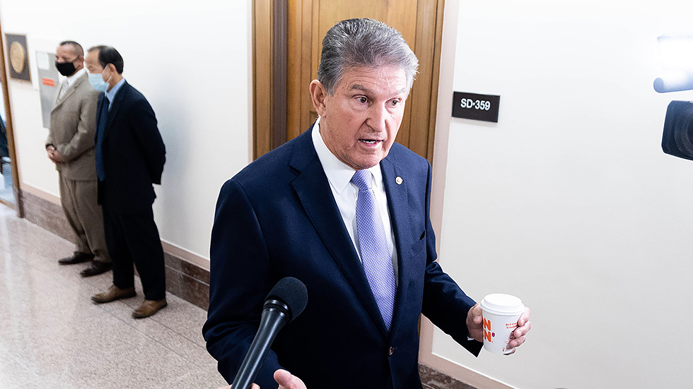 Sen. Joe Manchin (D-W.Va.) speaks to reporters prior to a  Senate Energy and Natural Resources Committee hearing  on Tuesday, Nov. 16, 2021.