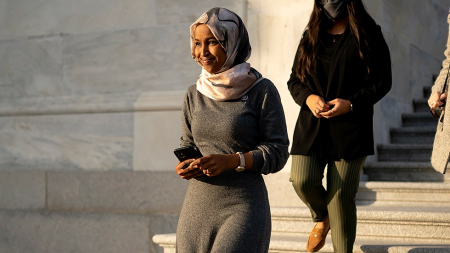 lRep. Ilhan Omar (D-Minn.) eaves the House Chamber following a series of votes regarding veterans on Tuesday, November 16, 2021.