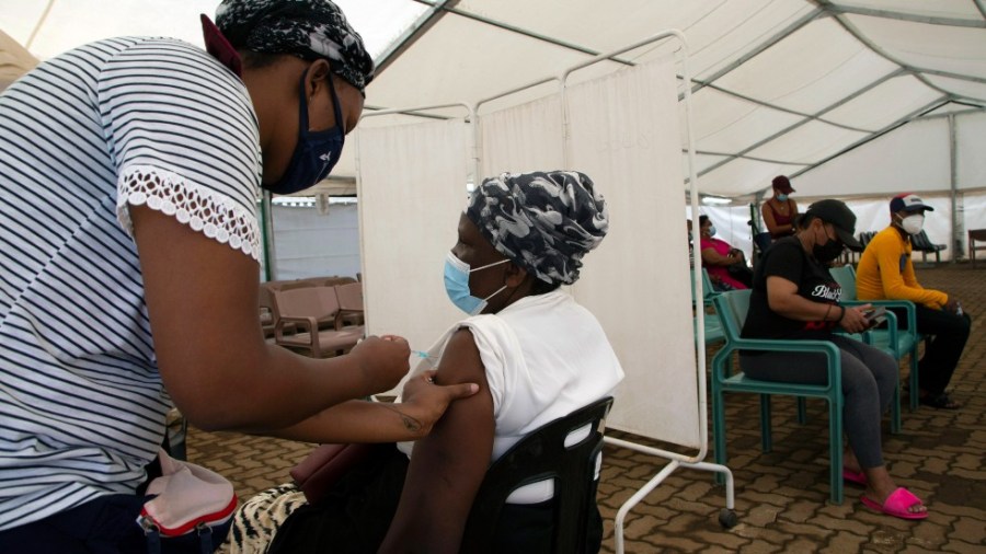 A woman receives a dose of a COVID-19 vaccine at a center, in Soweto, South Africa