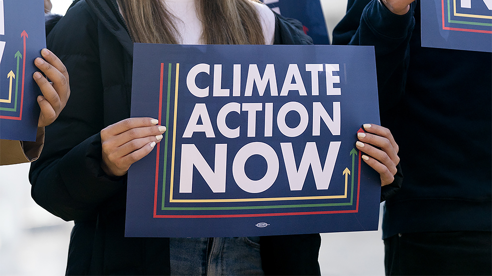 Climate advocates are seen during a press conference on Wednesday, December 1, 2021 to discuss climate change provisions in the Build Back Better Act.