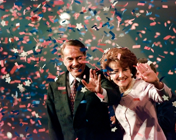 Bob Dole and his wife Elizabeth wave from the podium on the floor of the Republican National Convention in San Diego, Aug. 15, 1996