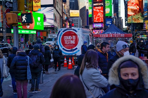 People wait in a long line to get tested for COVID-19 in Times Square, New York